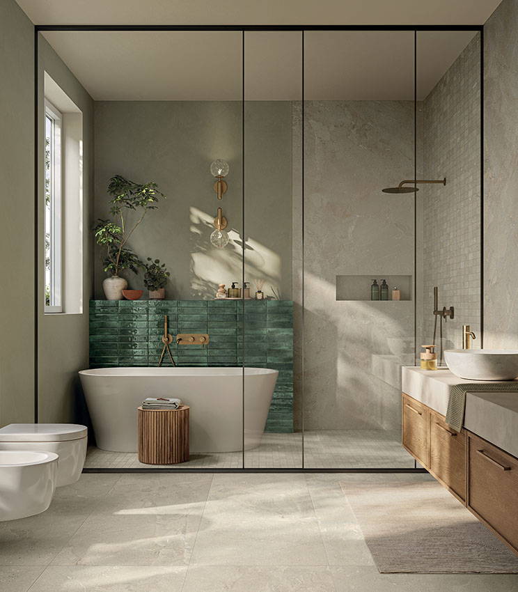 Contemporary bathroom featuring surfaces from the Revel Dune, Mosaico Dune and Workshop Jade collections, with a freestanding bathtub, glossy green wall, large glass shower, wooden vanity and natural light illuminating the neutral-toned surfaces.