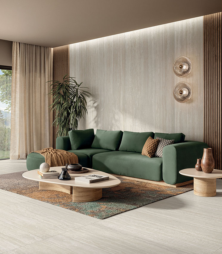 Elegant living room with travertine-effect porcelain stoneware flooring and wall covering, contemporary furnishings and natural tones for a warm, refined space.