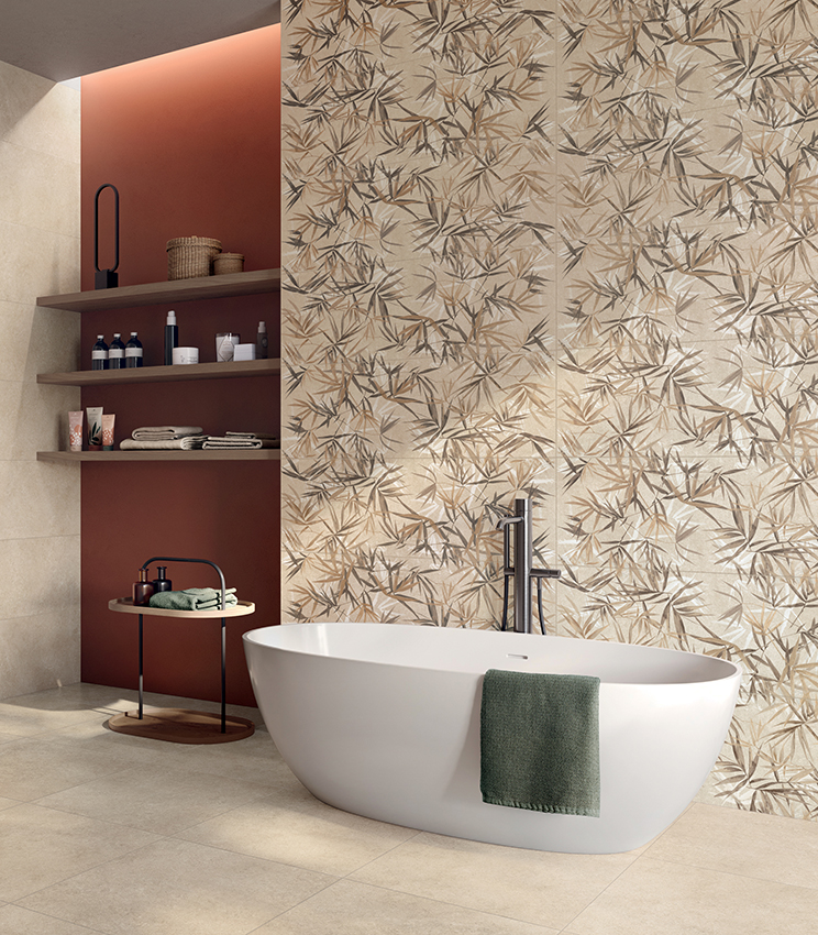 Contemporary bathroom with a freestanding bathtub, featuring surfaces from Panaria Ceramica’s Iqoniqa collection: the botanical Stalks Warm decoration defines the main wall, paired with the neutral tones of Velvet Naturale on the floor and walls.