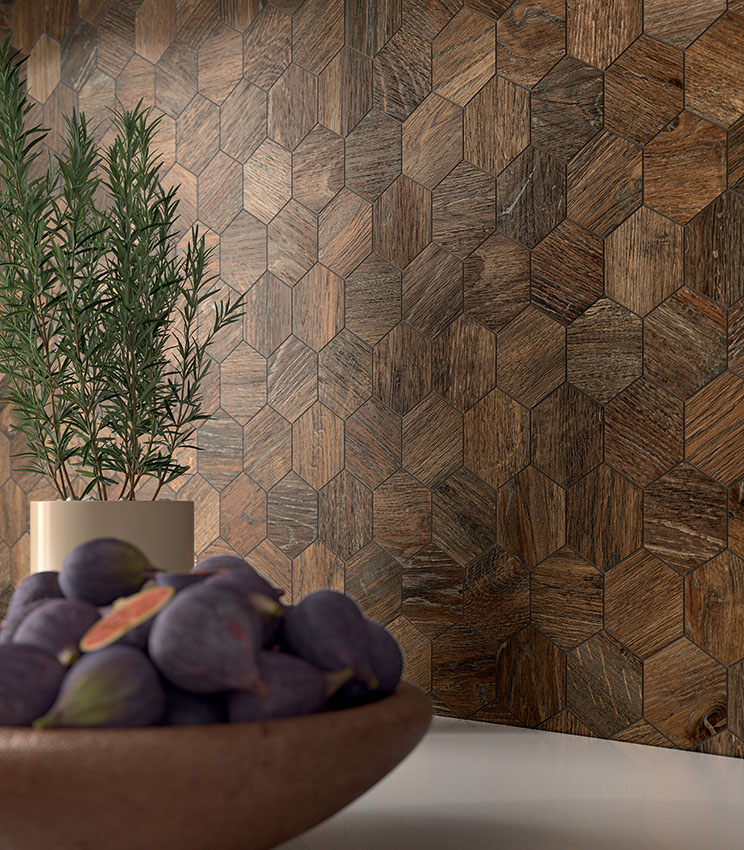 Close-up view of kitchen backsplash covered with dark wood-effect hexagonal porcelain stoneware mosaic tiles