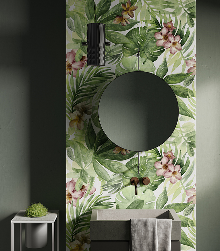 Frontal view of the washbasin wall in a small bathroom with full-height porcelain stoneware wallpaper-effect tiles featuring botanical patterns.